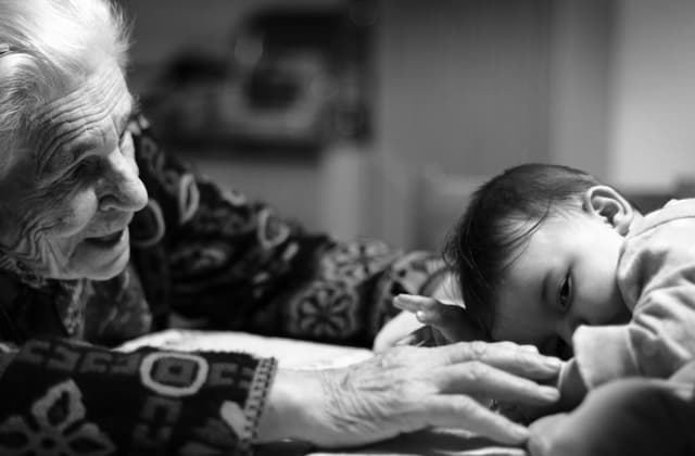 A baby held in his grandma