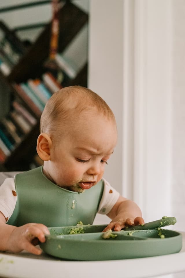 A baby eating his first meal